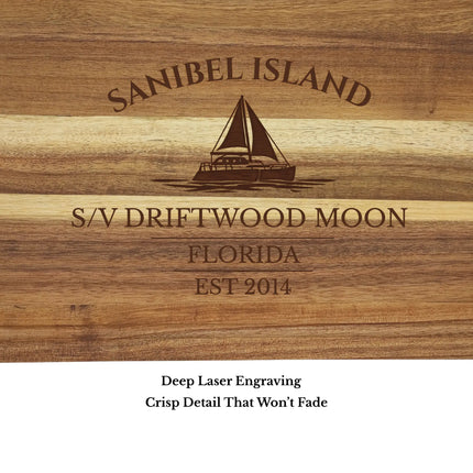 Close up of Sanibel Island Florida sailboat cutting board engraving showing detailed sailboat design and acacia wood grain