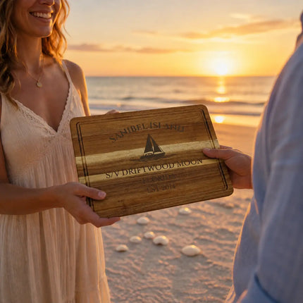 Sanibel Island Florida personalized cutting board being given as a gift on a beach at sunset with seashells and calm Gulf water