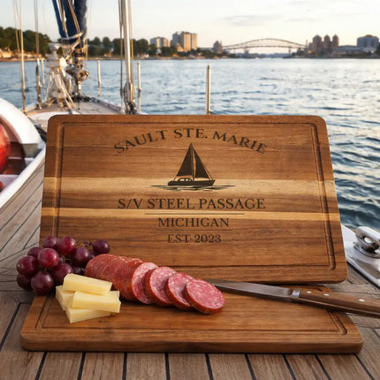 Personalized Sault Ste Marie cutting board displayed on sailboat deck with nautical gear representing sailor lifestyle and coastal living