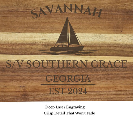 Close up of Savannah sailboat engraving on acacia wood cutting board showing detailed laser engraving quality