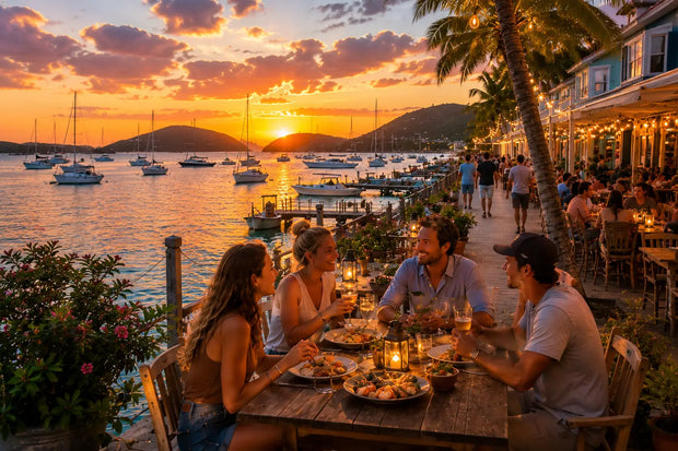 Friends enjoying waterfront dining at sunset overlooking anchored sailboats, Caribbean waters, and the vibrant harbor atmosphere of Simpson Bay Lagoon in Saint Martin.