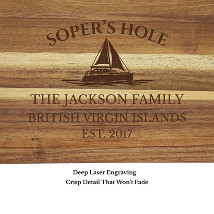 Close up of Soper’s Hole Harbor British Virgin Islands sailboat cutting board engraving showing detailed sailboat design and acacia wood grain