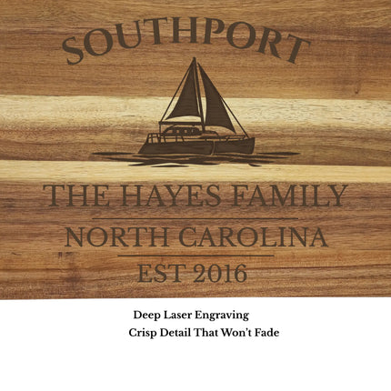 Close up of Southport North Carolina sailboat engraving on acacia wood cutting board showing detailed laser engraving quality