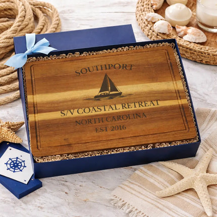 Southport sailboat cutting board presented in coastal nautical gift box with rope starfish and beach themed elements