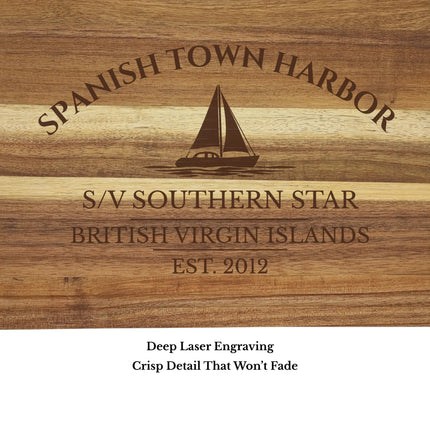 Close up of Spanish Town Harbor British Virgin Islands sailboat cutting board engraving showing detailed sailboat design and acacia wood grain