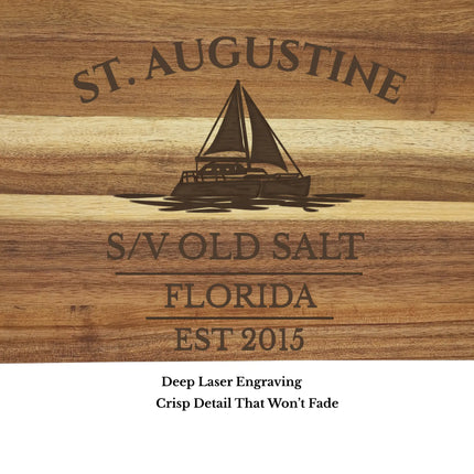 close up of st augustine sailboat cutting board engraving detail custom boat name on acacia wood