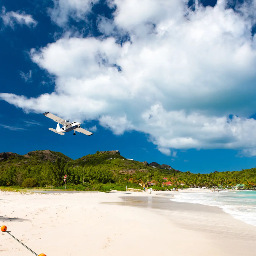 Aircraft approaching Gustaf III Airport above St. Jean Beach in St. Barths, one of the Caribbean's most famous airport landings.