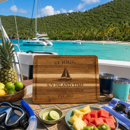 St John US Virgin Islands sailboat cutting board displayed beside turquoise Caribbean bays white sand beaches anchored catamarans and lush tropical hillsides