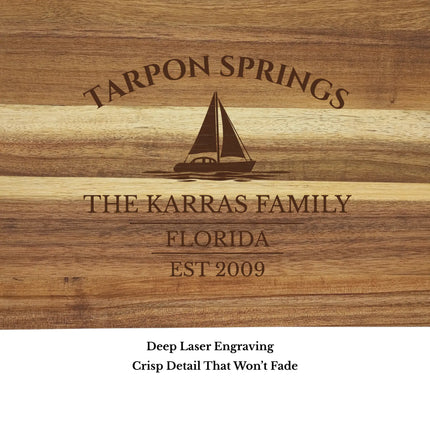 Close up of Tarpon Springs Florida sailboat cutting board engraving showing detailed sailboat design and acacia wood grain