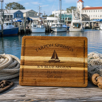 Tarpon Springs Florida sailboat cutting board on a working dock with ropes nets and small fishing boats in a sponge dock setting