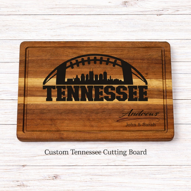 Custom Tennessee football cutting board with skyline engraving and personalized family name, solid acacia wood on whitewashed background