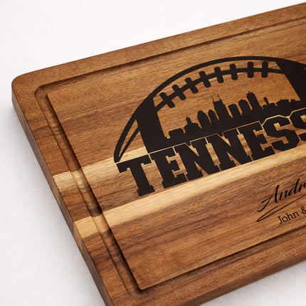 Close-up of Tennessee football cutting board showing smooth juice groove detail, solid acacia wood with deep natural laser engraving