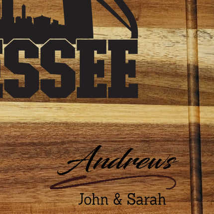 Close-up of personalized Tennessee football cutting board showing custom family name engraving in solid acacia wood