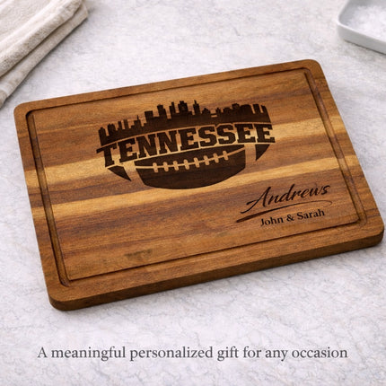 Tennessee football cutting board displayed on kitchen countertop as a personalized gift, solid acacia wood with laser engraved skyline and custom family name