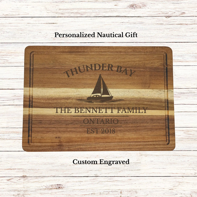 Personalized Thunder Bay Ontario sailboat cutting board engraved with boat name and established date on premium acacia wood nautical gift
