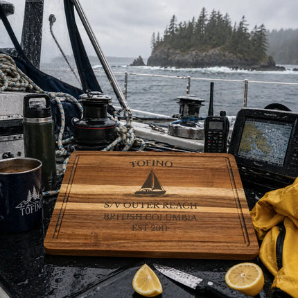 Tofino British Columbia sailboat cutting board on a wet cockpit table with navigation gear rope radio and coastal weather conditions on the open Pacific