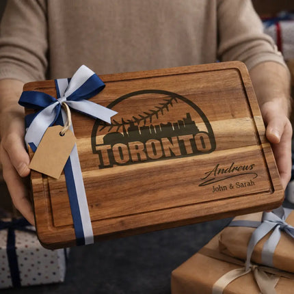 Personalized Toronto baseball cutting board presented as a gift with blue and white ribbon and wrapped boxes