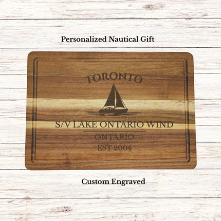 Personalized Toronto Ontario sailboat cutting board engraved with boat name and established date on premium acacia wood nautical gift