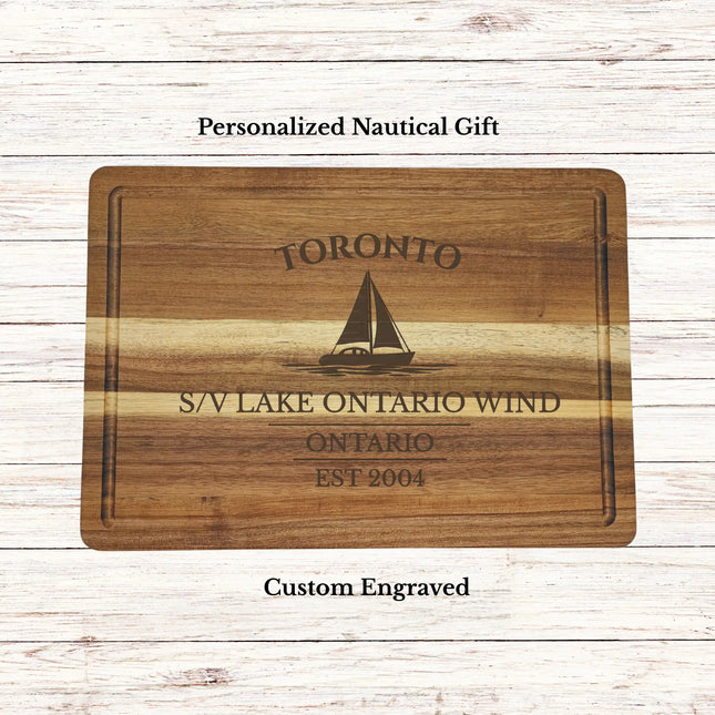 Personalized Toronto Ontario sailboat cutting board engraved with boat name and established date on premium acacia wood nautical gift