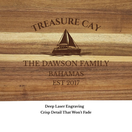 Close up of Treasure Cay Bahamas sailboat cutting board engraving showing detailed sailboat design and acacia wood grain