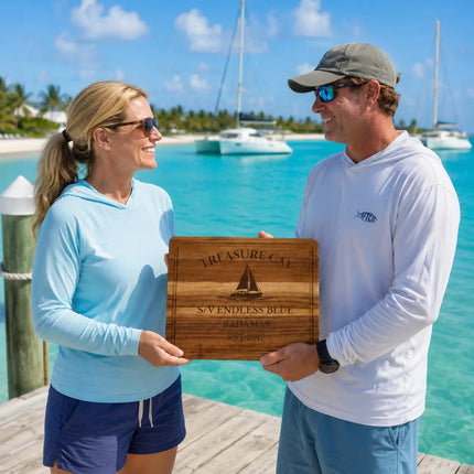 Treasure Cay Bahamas personalized cutting board being exchanged as a gift near turquoise Caribbean water and white sand beach in the Abacos