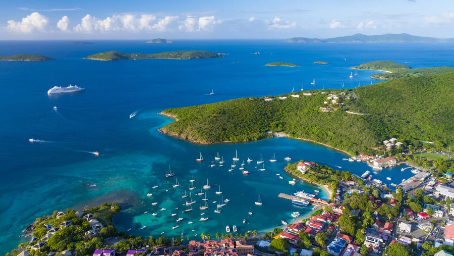 Aerial view of Cruz Bay on St. John in the U.S. Virgin Islands, featuring protected anchorages, sailboats, and the surrounding Caribbean islands.