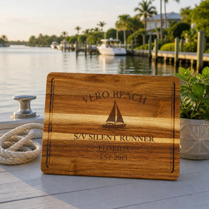 Vero Beach Florida sailboat cutting board on a dock near calm Indian River Lagoon water with residential waterfront background