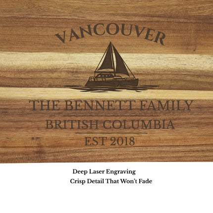 Close up of Victoria British Columbia sailboat cutting board engraving showing detailed sailboat design and natural acacia wood grain