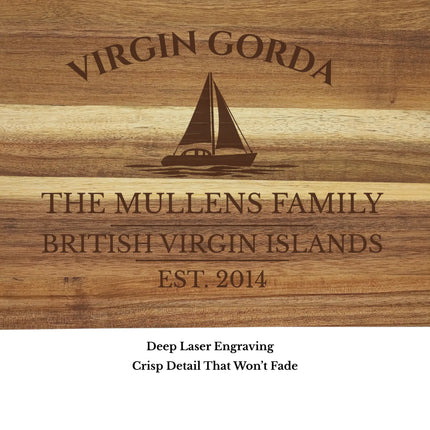 Close up of Virgin Gorda British Virgin Islands sailboat cutting board engraving showing detailed sailboat design and acacia wood grain