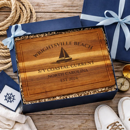 Wrightsville Beach sailboat cutting board presented in nautical themed gift box with rope compass and coastal decor